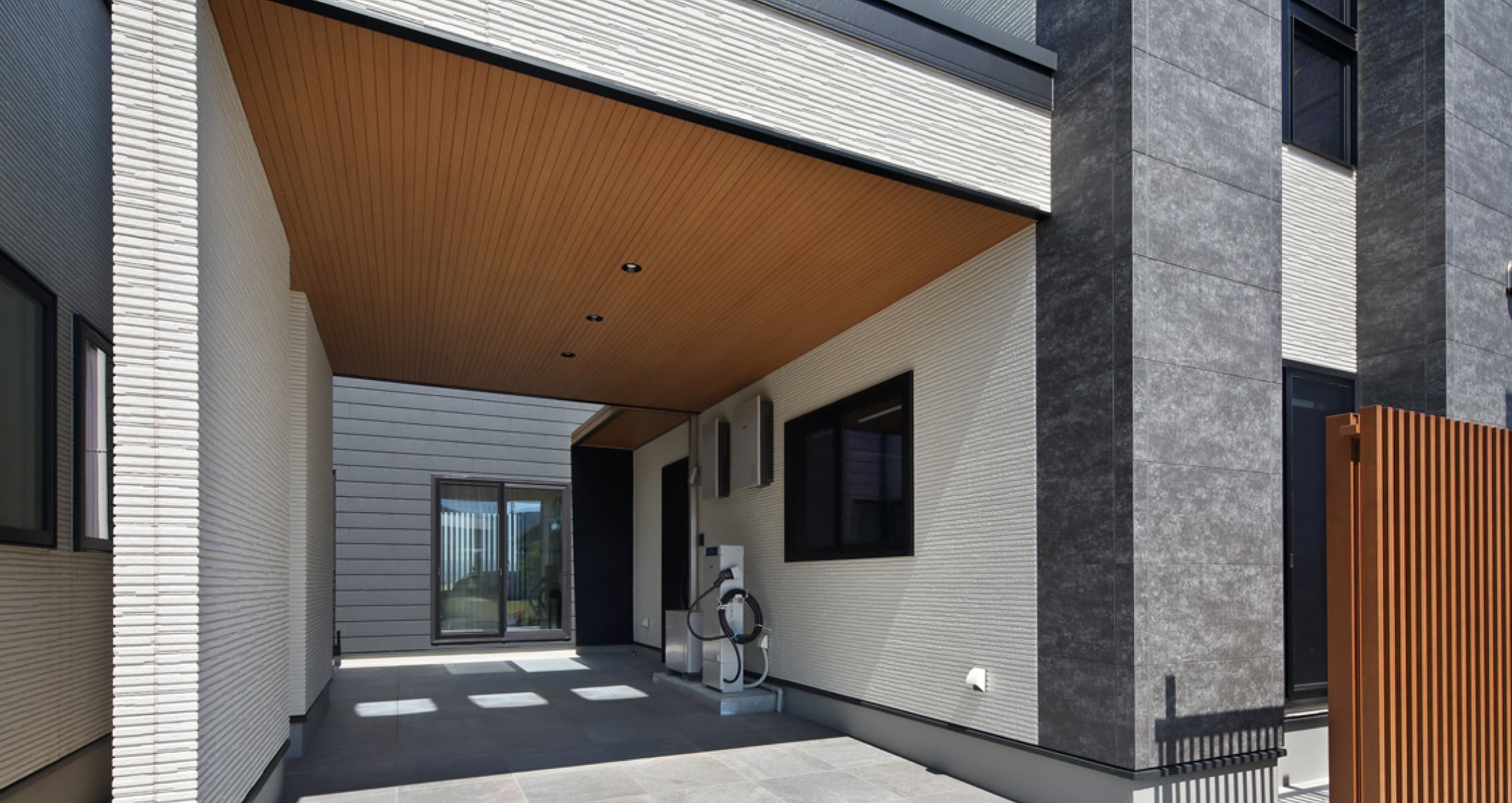 福井 家の森展示場のアプローチ。木の天井と充電設備